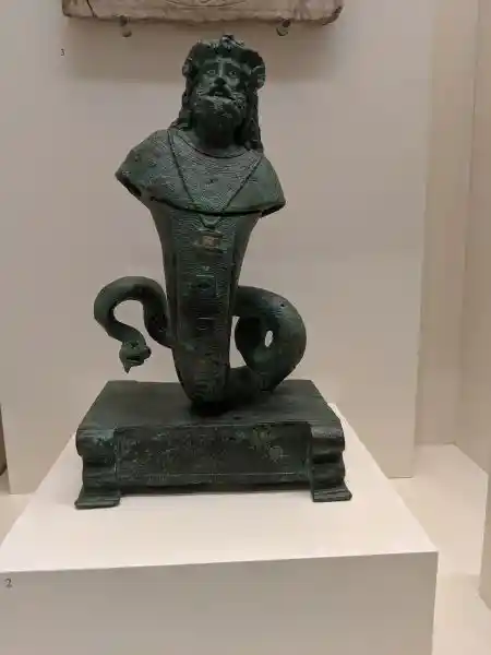 Display of rare Sarapis Amun statuette, zodiac marble, and protective figure with exaggerated features
